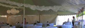 Wedding tables under a tent rented from Big T Tents.